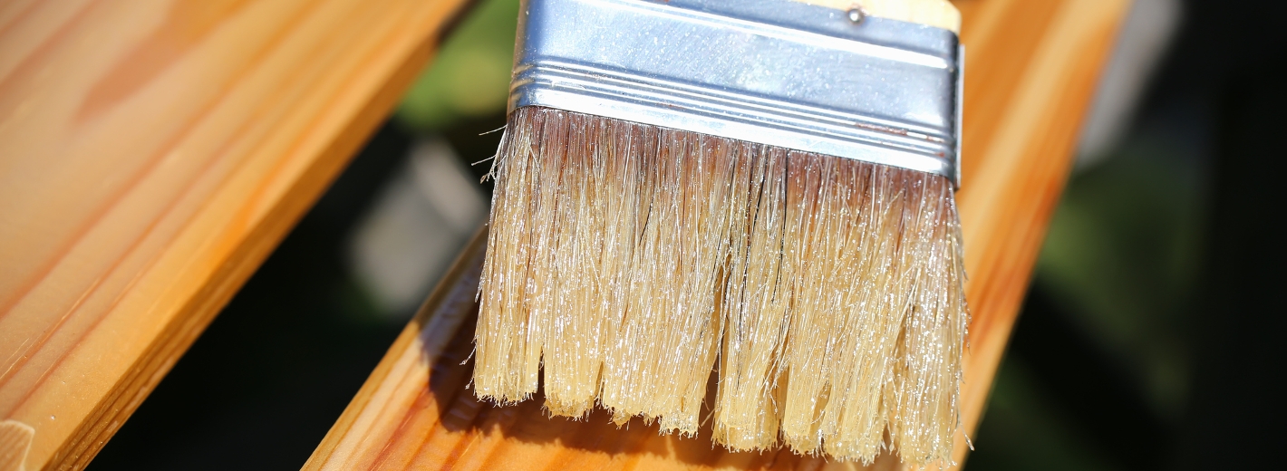 Pinsel streicht Zaun