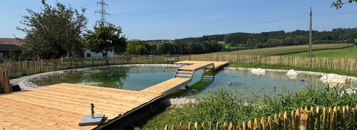 Foto von Naturteich mit Steg und Brücke aus Holu